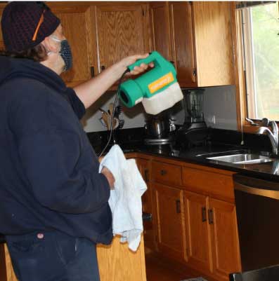 Tech using fogger for Home Disinfectant service